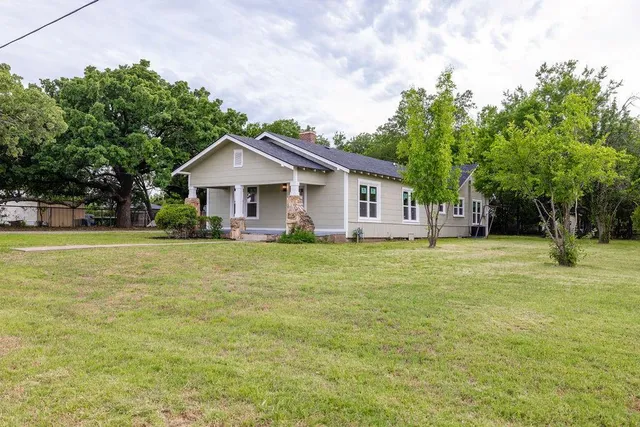 a front view of a house with a garden