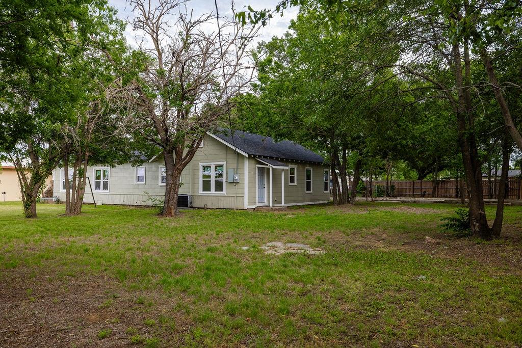 711 Fannin Street Nocona, TX 76255 - Photo 33 of 35 a view of a house with yard and tree s