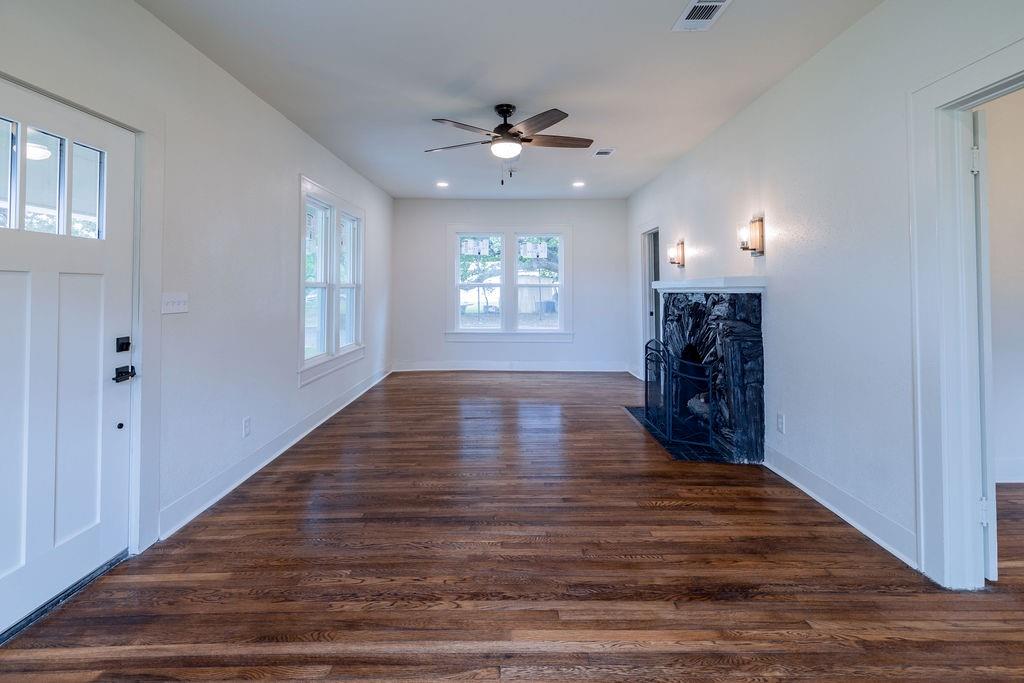 711 Fannin Street Nocona, TX 76255 - Photo 4 of 35 a view of an empty room with window and wooden floor