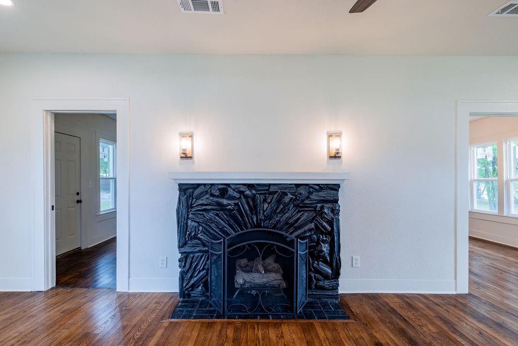 711 Fannin Street Nocona, TX 76255 - Photo 6 of 35 a living room with furniture and a fireplace
