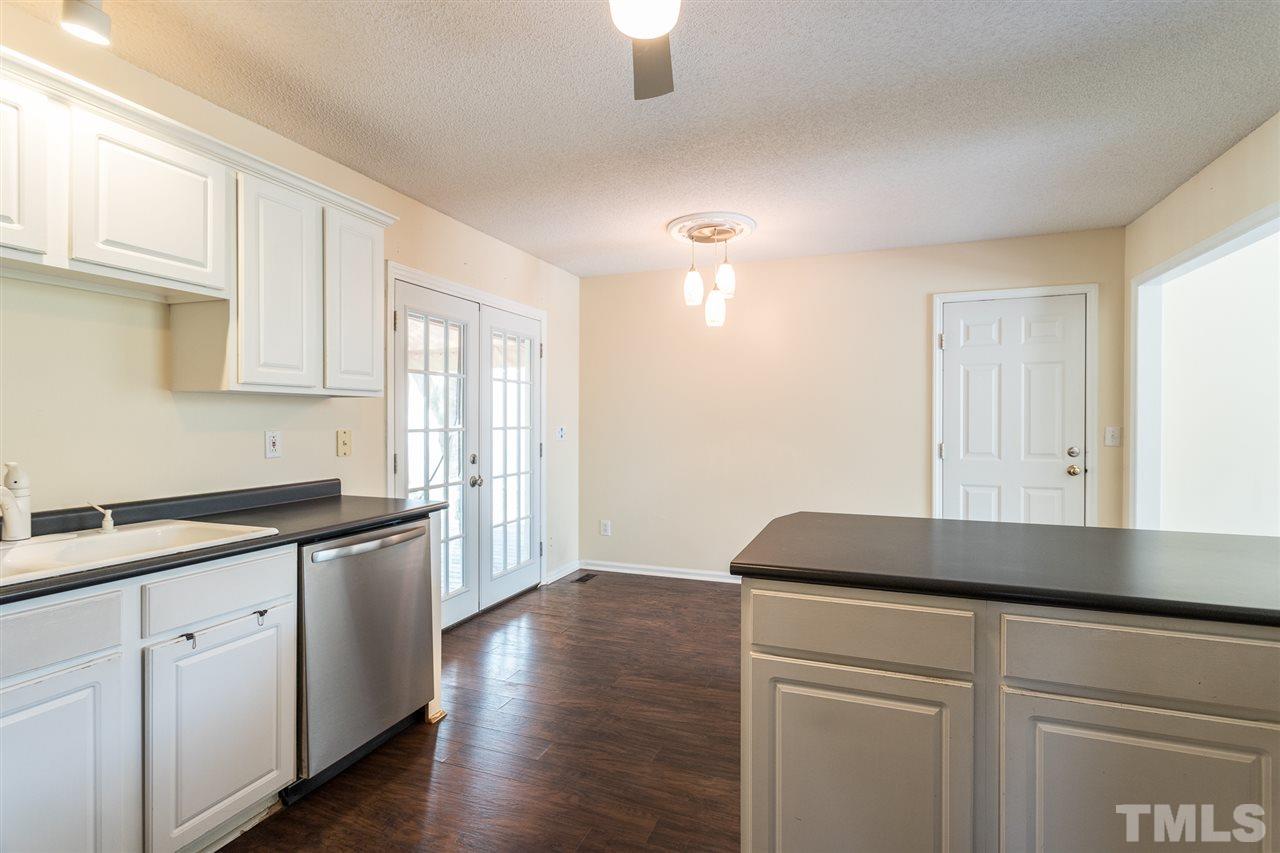 2100 Havering Place Raleigh, NC 27604 - Photo 13 of 27 a kitchen with granite countertop white cabinets and a wooden floor