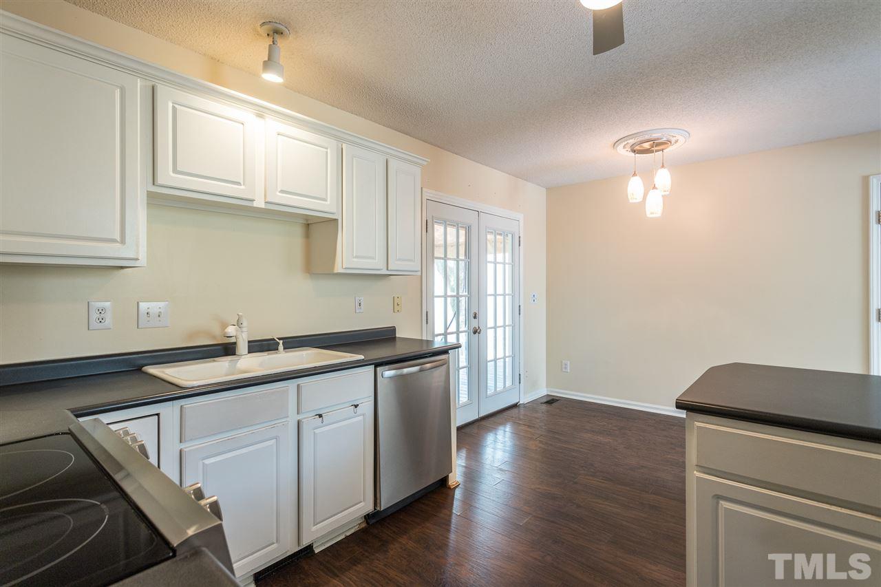 2100 Havering Place Raleigh, NC 27604 - Photo 14 of 27 a kitchen with a sink cabinets and wooden floor