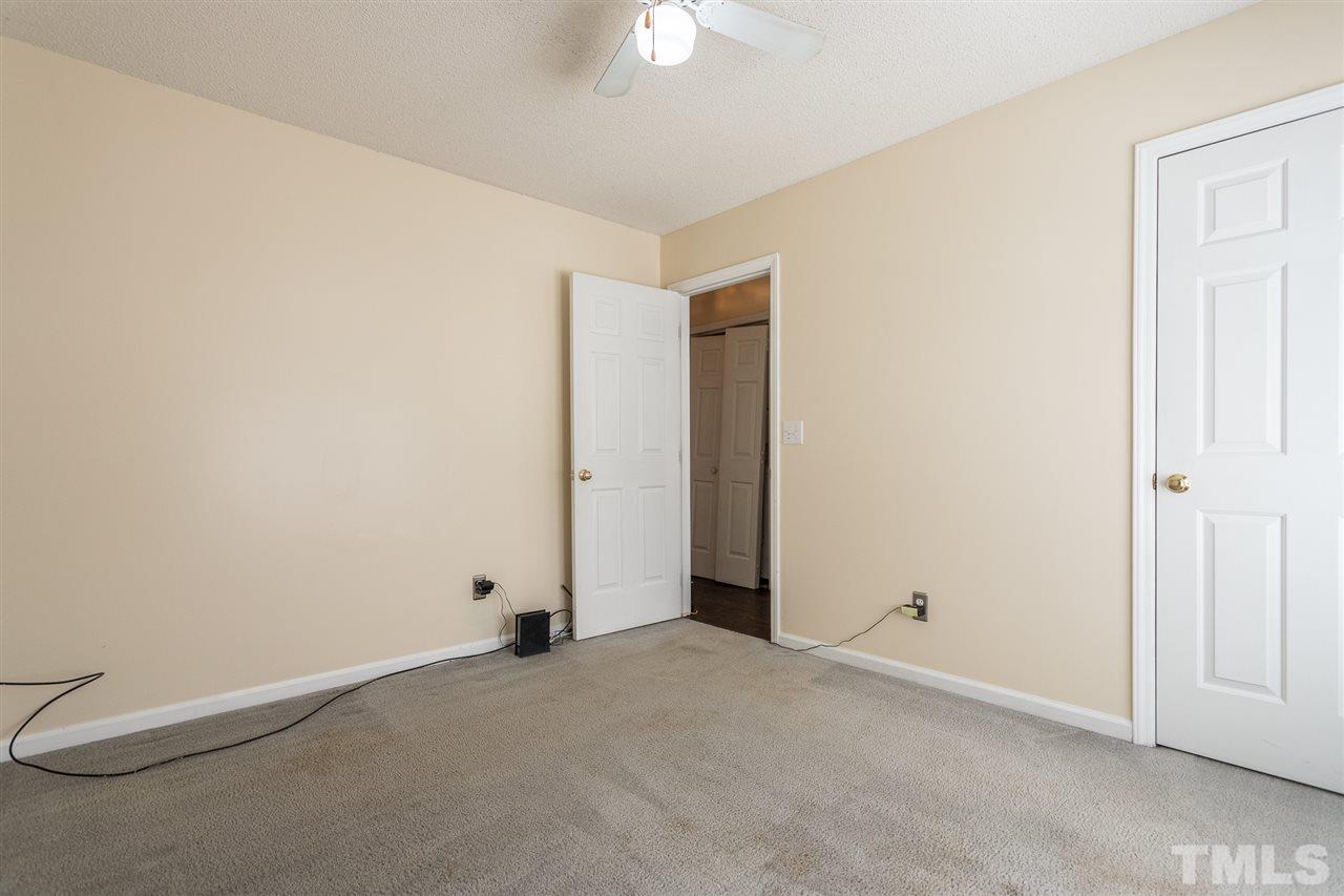 2100 Havering Place Raleigh, NC 27604 - Photo 16 of 27 an empty room with a ceiling fan and closet area