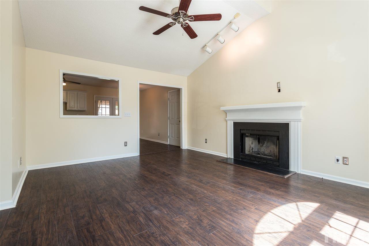 2100 Havering Place Raleigh, NC 27604 - Photo 3 of 27 a view of empty room with wooden floor and fireplace