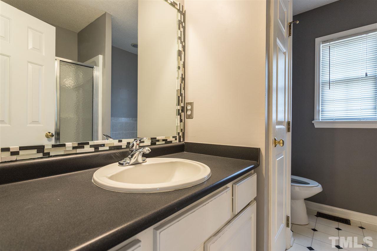2100 Havering Place Raleigh, NC 27604 - Photo 22 of 27 a bathroom with a sink and a mirror