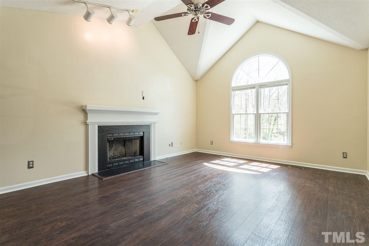 2100 Havering Place Raleigh, NC 27604 - Photo 5 of 27 an empty room with wooden floor fan and windows