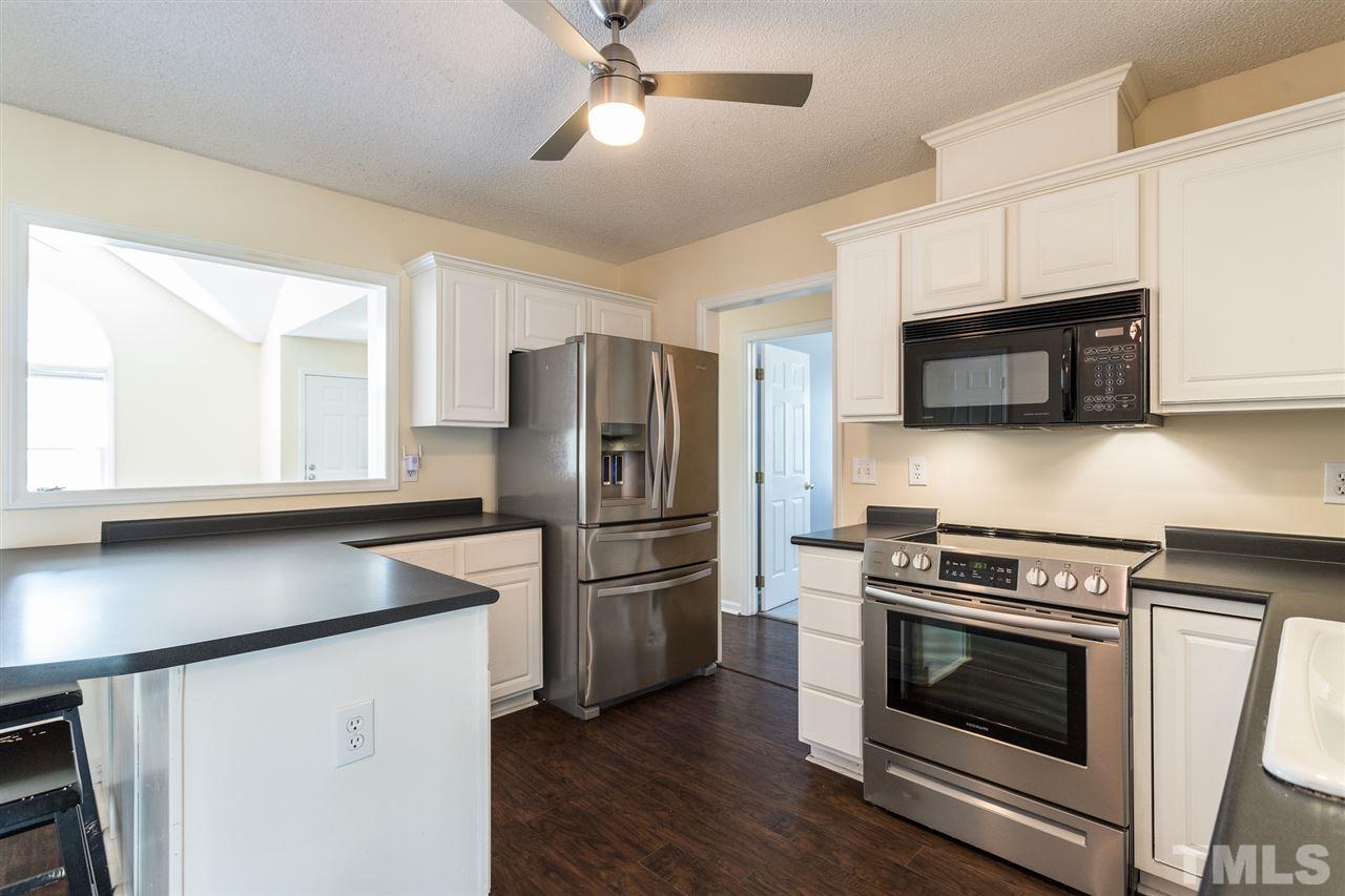 2100 Havering Place Raleigh, NC 27604 - Photo 9 of 27 a kitchen with stainless steel appliances a stove microwave and a refrigerator
