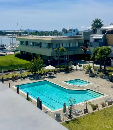 an aerial view of a house with swimming pool patio and outdoor seating