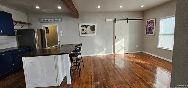 a view of a refrigerator in kitchen and wooden floor