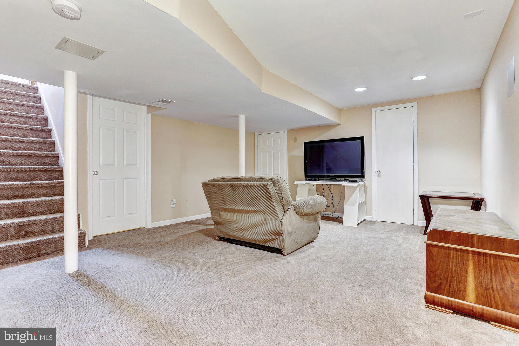 4433 Walnut Road Baltimore, MD 21227 - Photo 14 of 25 a living room with furniture and a flat screen tv