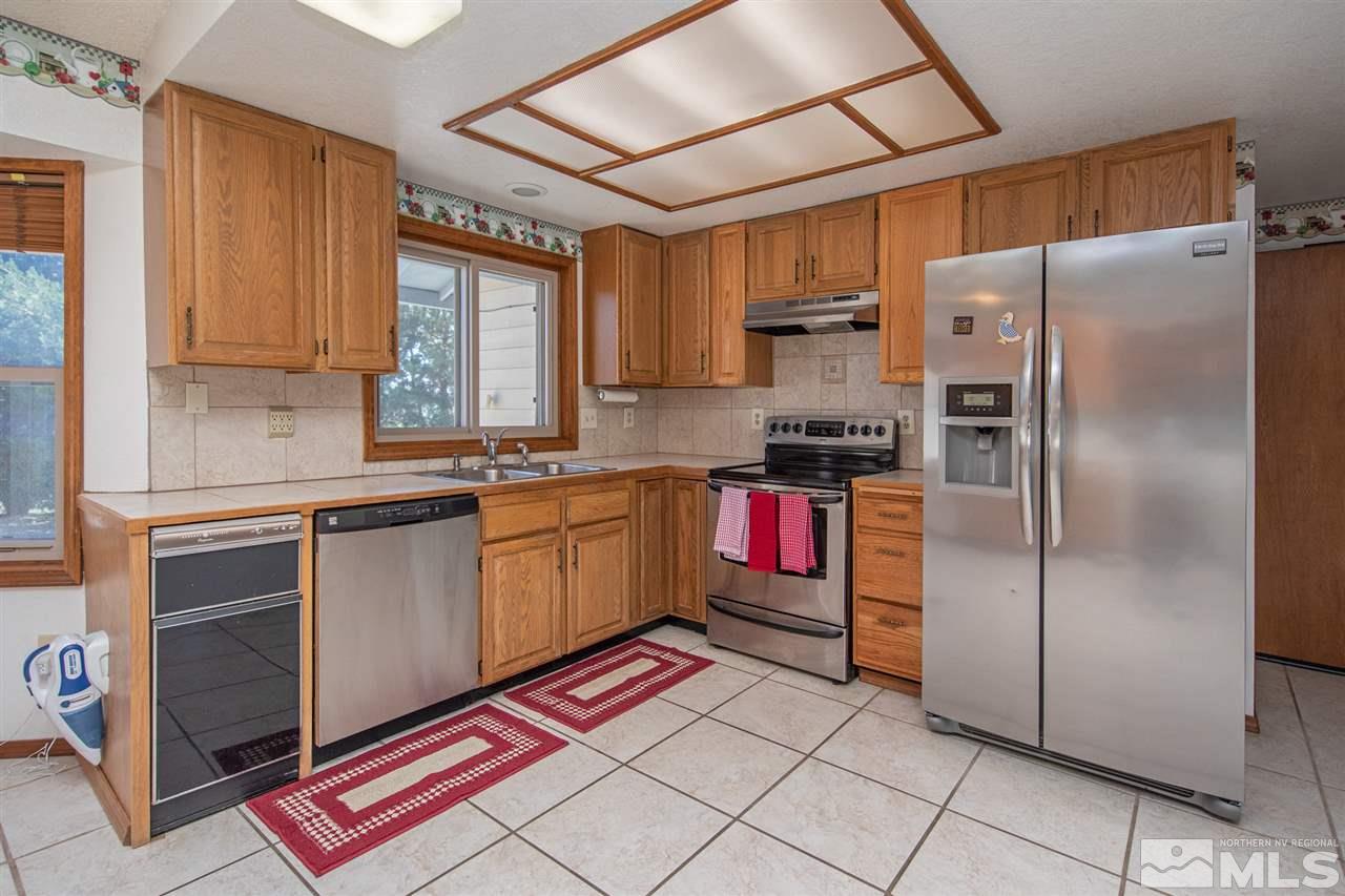 855 Lampe Road Reno, NV 89511 - Photo 4 of 30 a kitchen with stainless steel appliances granite countertop a refrigerator sink and cabinets