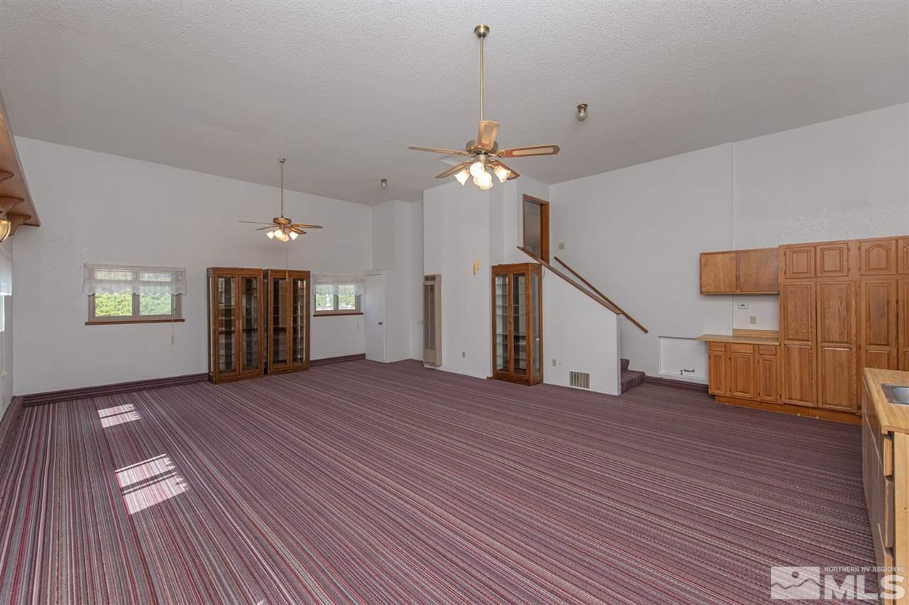 855 Lampe Road Reno, NV 89511 - Photo 8 of 30 a view of an empty room with window and wooden floor