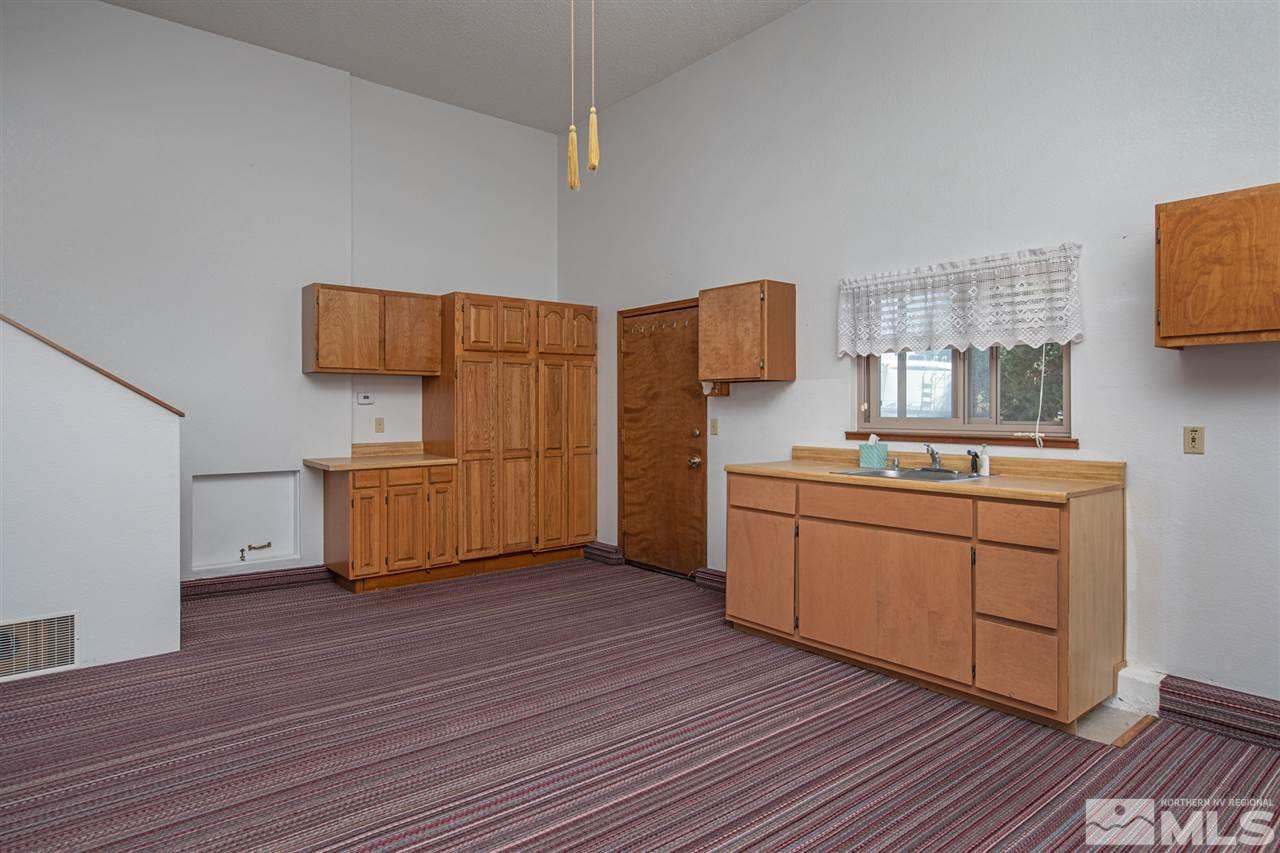 855 Lampe Road Reno, NV 89511 - Photo 9 of 30 a kitchen with sink cabinets and wooden floor