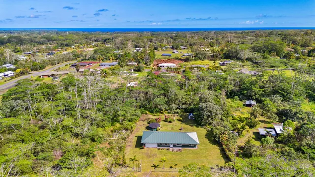 a kitchen with granite countertop a refrigerator a sink dishwasher a stove and white cabinets with wooden floor