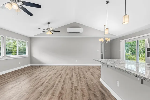 a kitchen with stainless steel appliances granite countertop wooden cabinets a sink dishwasher a stove and a refrigerator