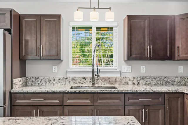 a kitchen with a sink stove top oven and microwave