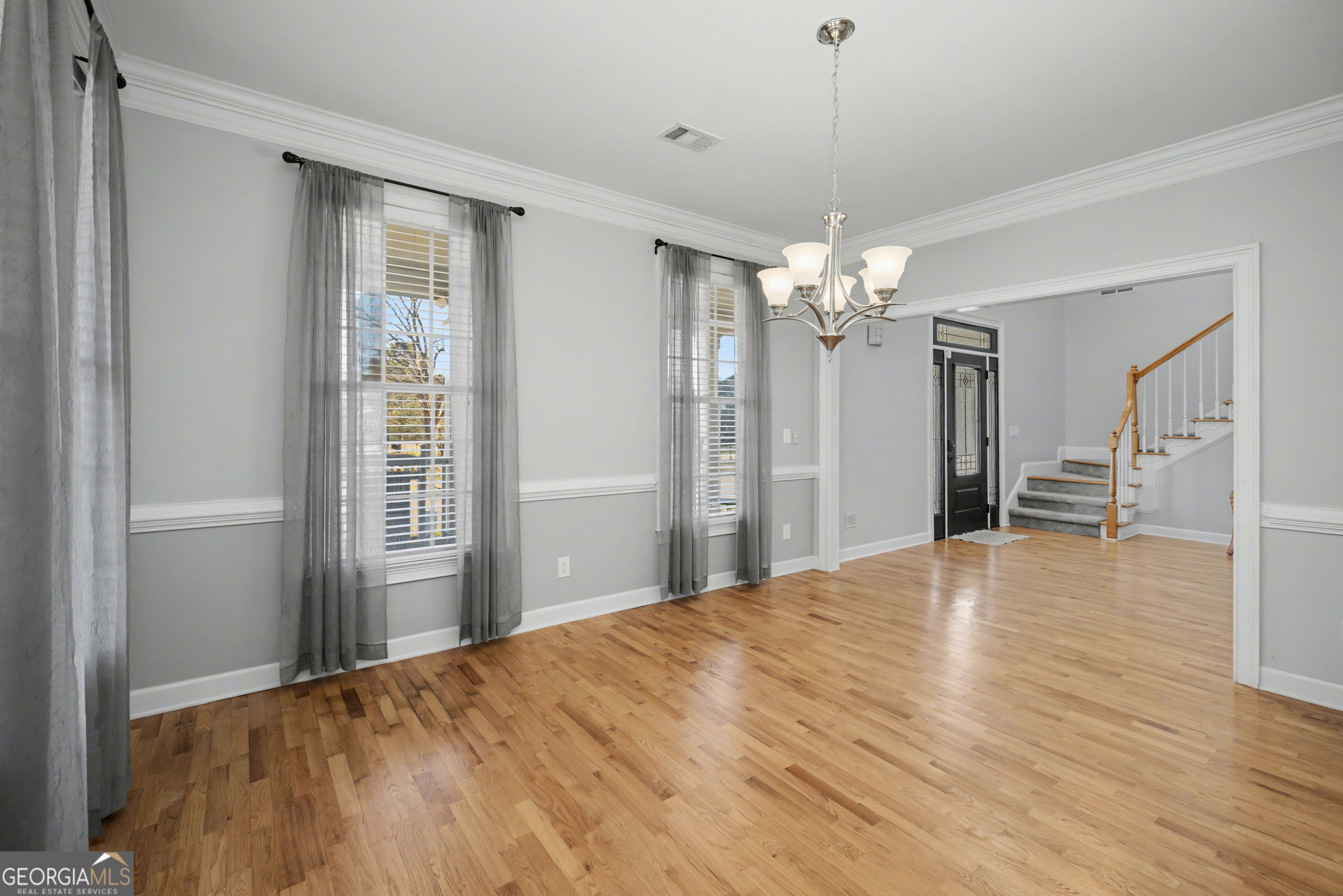 159 Friar Tuck Road Fayetteville, GA 30215 - Photo 11 of 68 a view of a livingroom with wooden floor and a chandelier