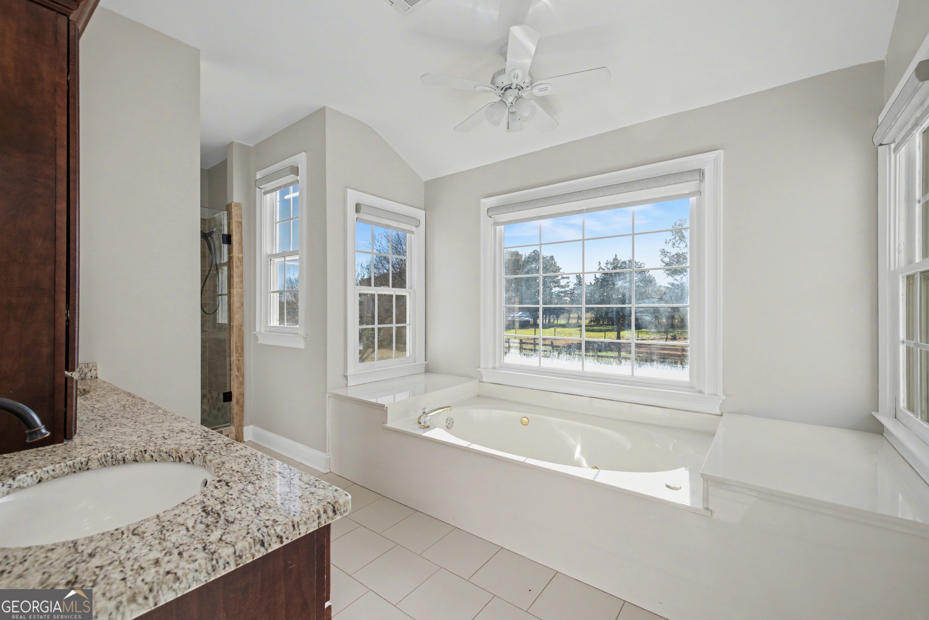 159 Friar Tuck Road Fayetteville, GA 30215 - Photo 21 of 68 a bathroom with a granite countertop tub sink and mirror