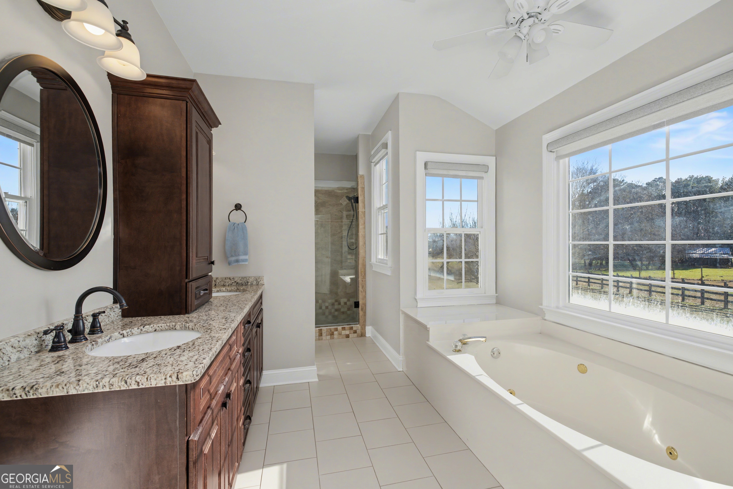 159 Friar Tuck Road Fayetteville, GA 30215 - Photo 22 of 68 a spacious bathroom with a granite countertop tub and a sink
