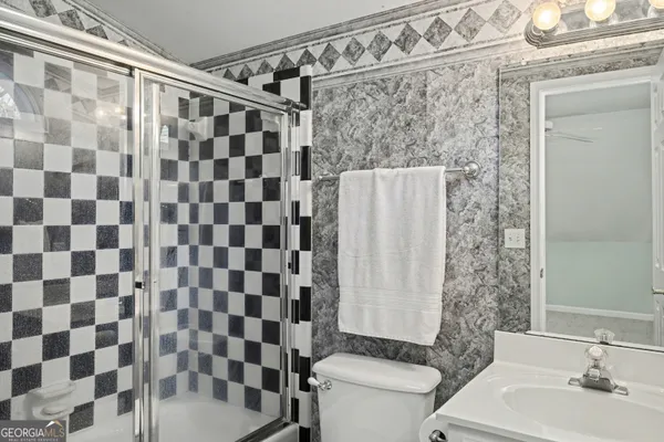 a bathroom with a double vanity sink mirror and shower