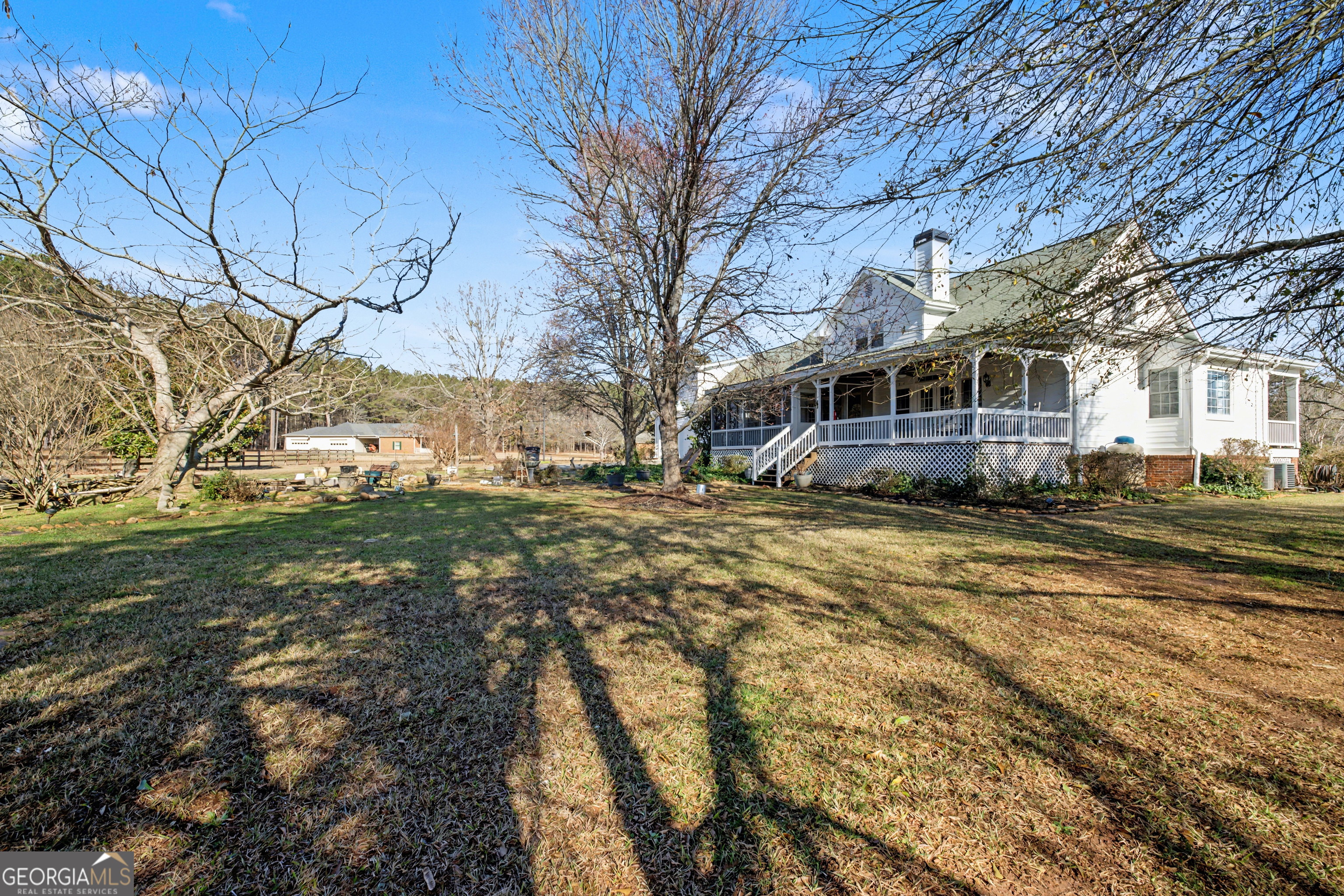 159 Friar Tuck Road Fayetteville, GA 30215 - Photo 45 of 68 a view of a large white house with a yard