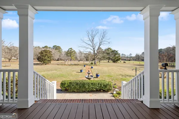 a view of a balcony with lake view and wooden floor