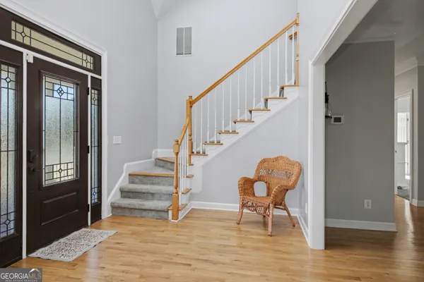 a view of entryway and hall with wooden floor