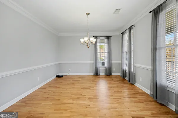 a view of a room with window and wooden floor