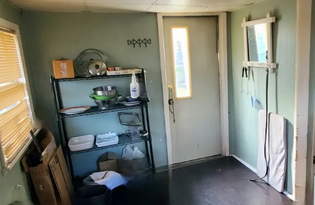 a bed room with a bed and a painting on the wall