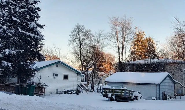 a view of a house with a yard and sitting area
