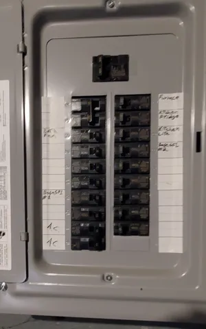 a view of a wooden house with a small yard and wooden fence