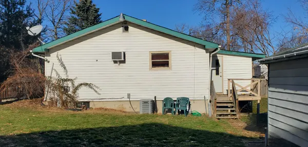 a front view of a house with a tree