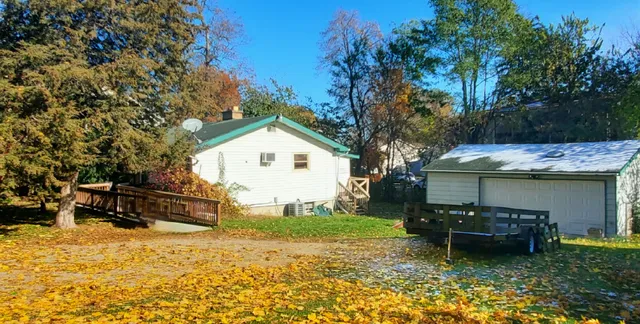 a view of a house with backyard and sitting area