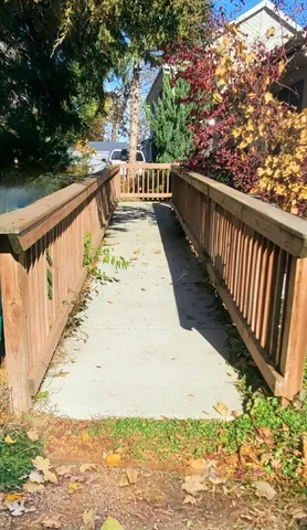 a view of balcony with wooden floor and fence