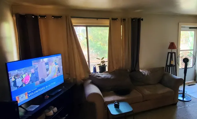 a living room with furniture and a large window