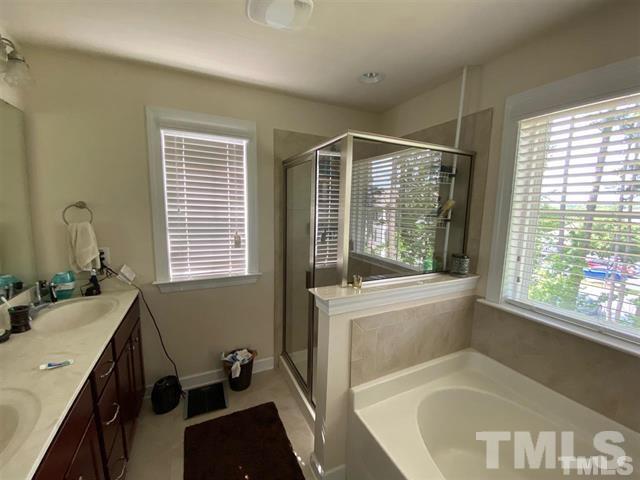 2424 Pecan Ridge Way Apex, NC 27502 - Photo 6 of 9 a bathroom with a tub sink and a window
