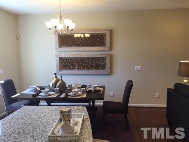2424 Pecan Ridge Way Apex, NC 27502 - Photo 7 of 9 a view of a dining room with furniture and chandelier