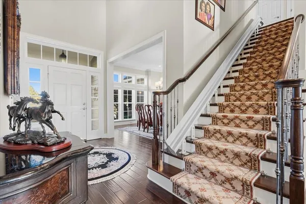 a bathroom with a granite countertop sink a toilet and a mirror