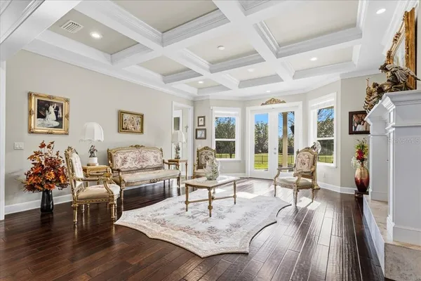 a bedroom with a bed a large window with table and chairs
