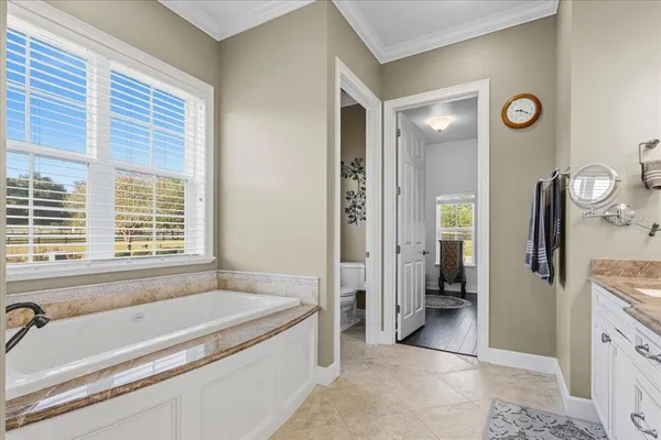 a view of a hallway with wooden floor and windows