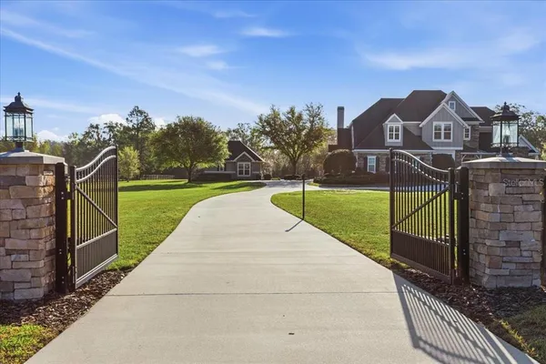 a view of a house with a yard and sitting area