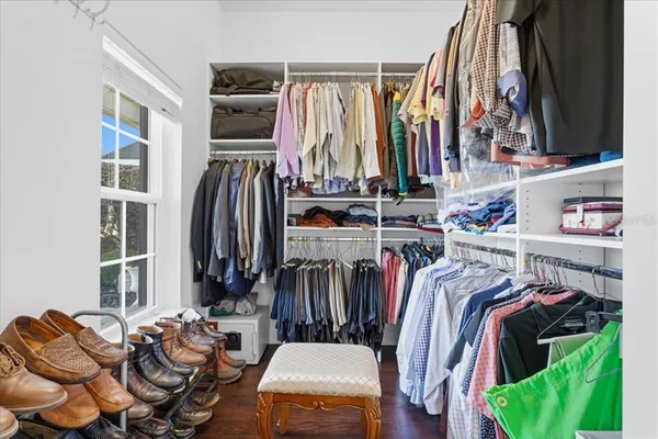 a living room with furniture a flat screen tv and a window