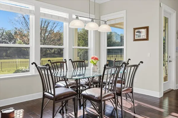 a view of a hallway with wooden floor and stairs