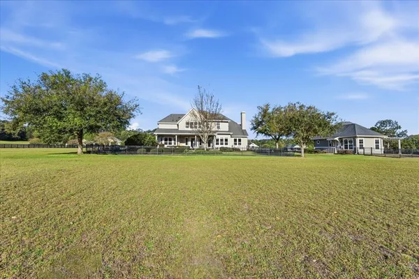 a view of a house with a yard balcony and sitting area