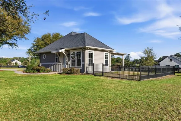 a front view of a house with a yard table and chairs