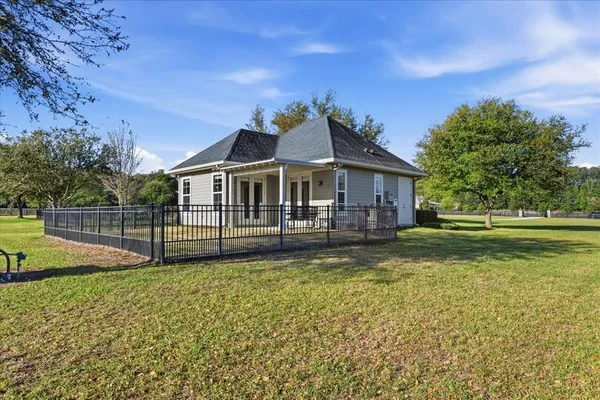 a view of a dining room with furniture wooden floor and chandelier