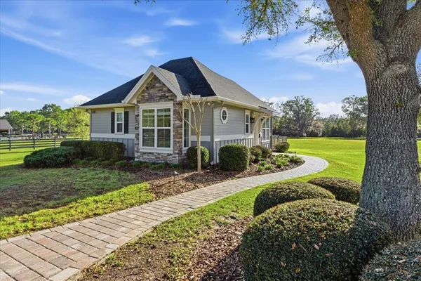 a view of a dining room with furniture a chandelier and wooden floor