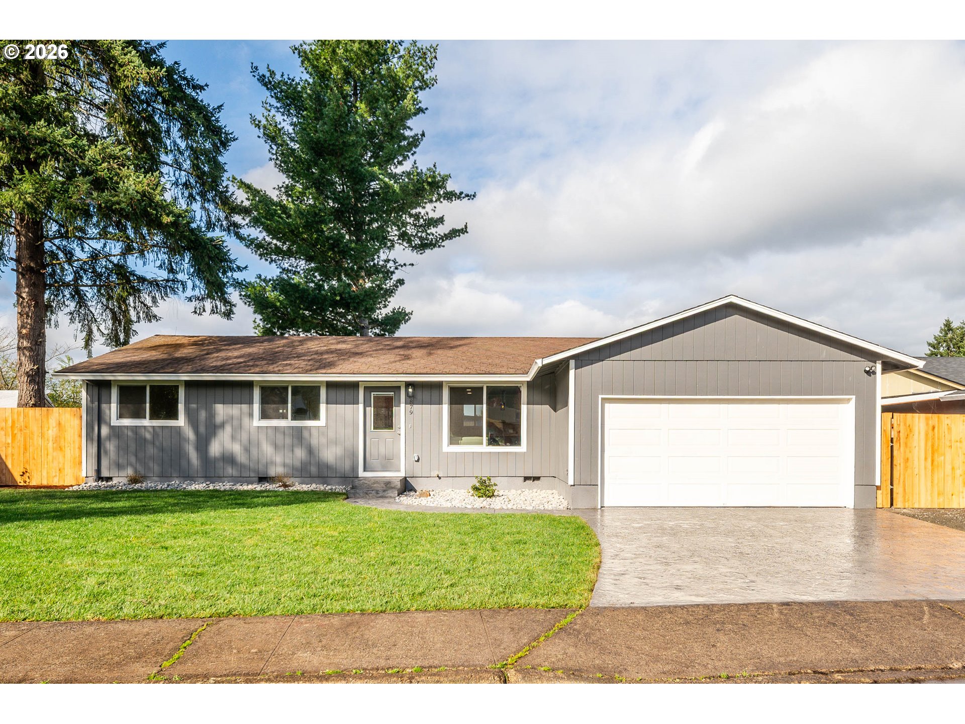 879 North Broadway Street Estacada, OR 97023 - Photo 1 of 37 a front view of a house with a yard and potted plants