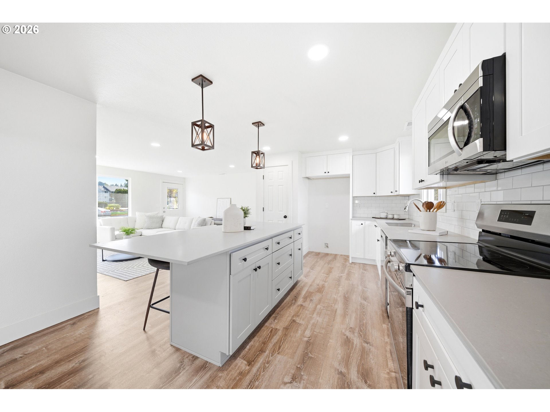879 North Broadway Street Estacada, OR 97023 - Photo 11 of 37 a kitchen with kitchen island white cabinets and stainless steel appliances