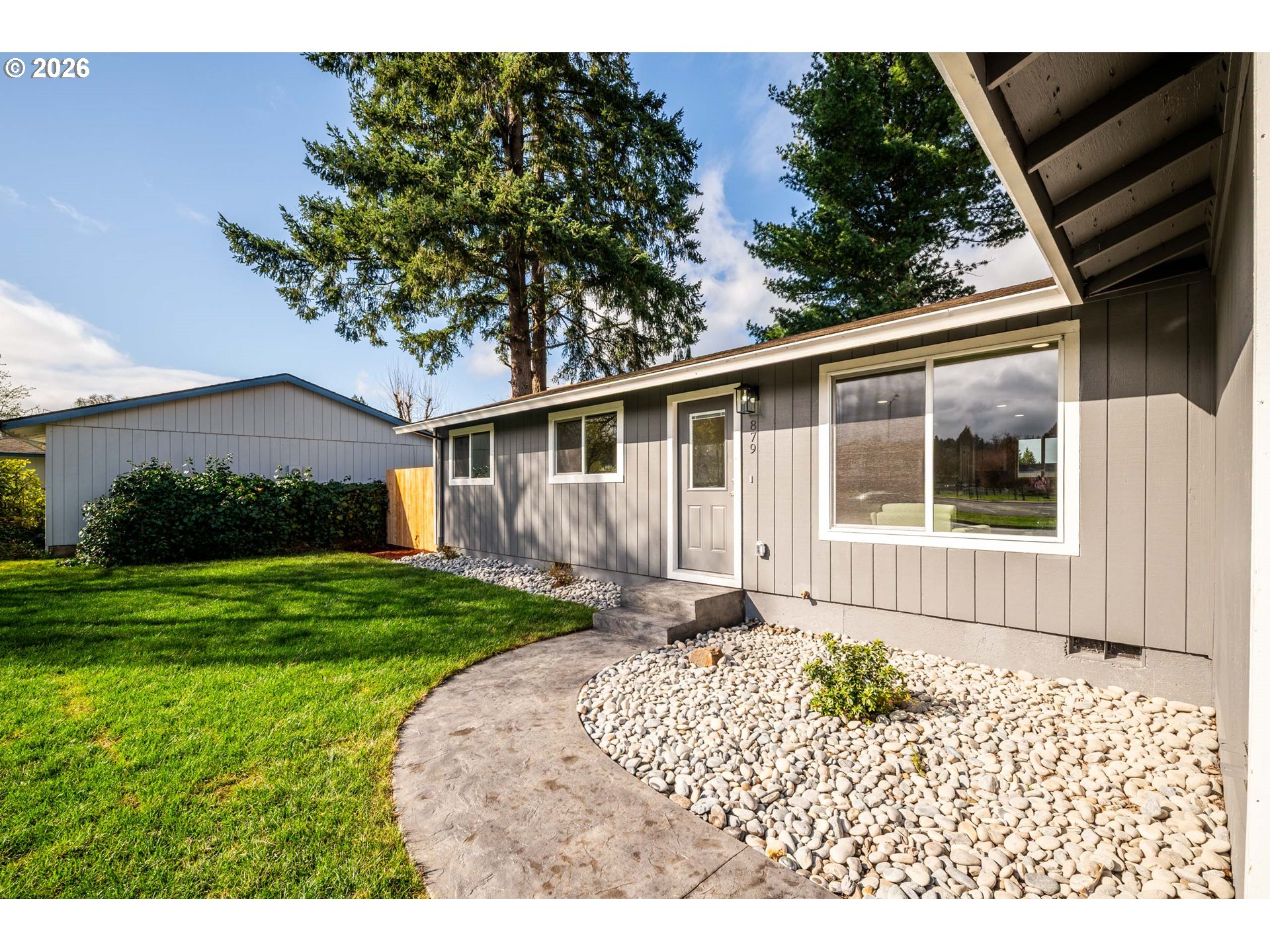 879 North Broadway Street Estacada, OR 97023 - Photo 4 of 37 a front view of a house with garden